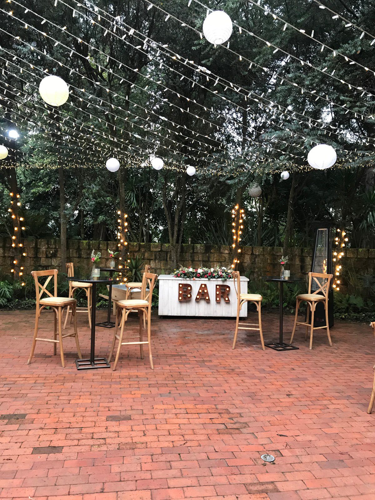 sa coctelera alta de mármol acompañada de sillas crossback altas en boda.