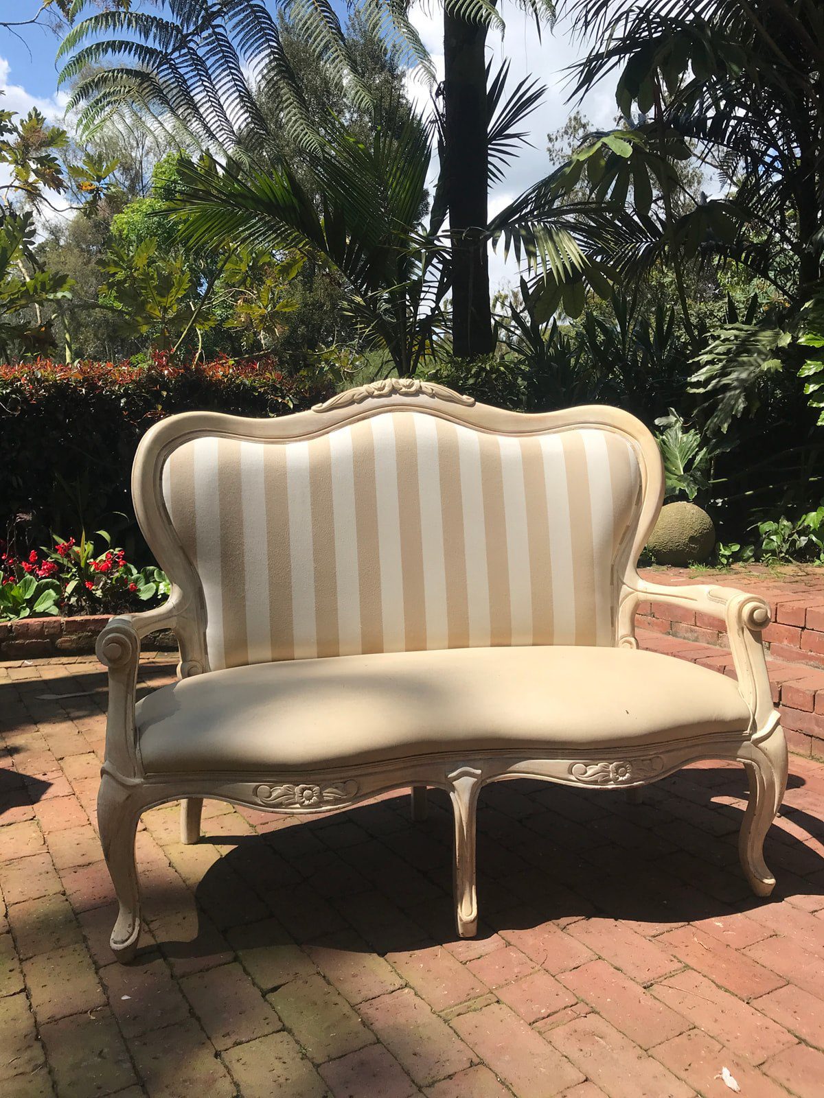 Sofá Isabelina de rayas café colocado en jardín para boda romántica en Casa Aragón.